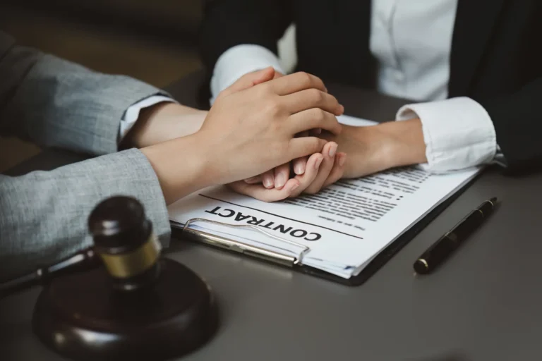 Stoneham business attorney supporting a client while reviewing and finalizing a business contract.